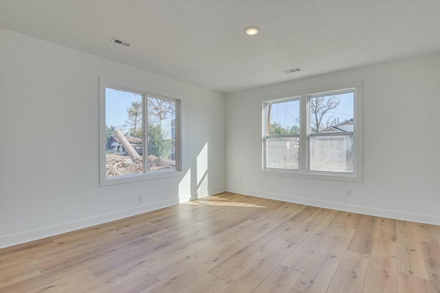 unfurnished room featuring light hardwood / wood-style floors