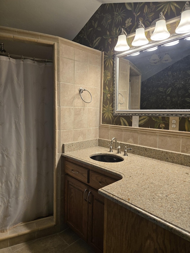 bathroom featuring vaulted ceiling and vanity