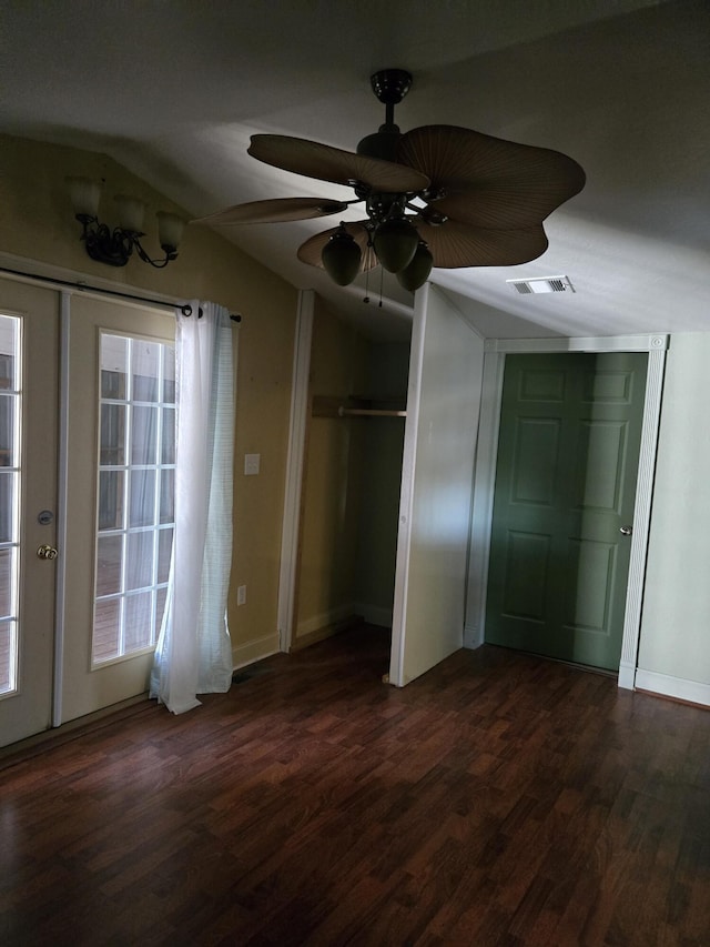 unfurnished bedroom with french doors, ceiling fan, vaulted ceiling, and dark hardwood / wood-style floors