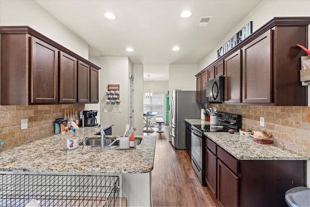 152 Sims Ct, Augusta, GA 30909 - kitchen featuring black appliances, a peninsula, dark wood-style floors, a sink, and backsplash