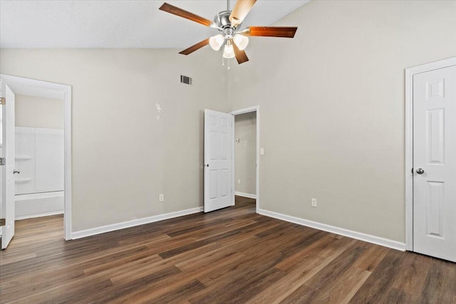 unfurnished bedroom featuring vaulted ceiling, wood finished floors, visible vents, and baseboards