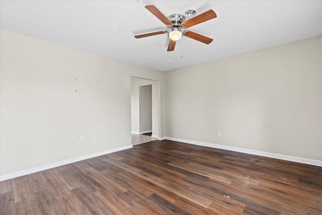 unfurnished room featuring a ceiling fan, baseboards, and wood finished floors