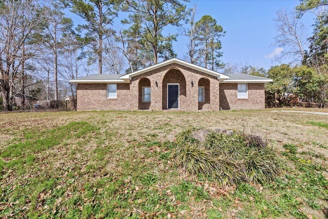 ranch-style home with brick siding and a front lawn