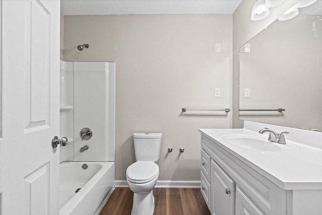 full bath featuring baseboards, toilet, shower / tub combination, wood finished floors, and vanity