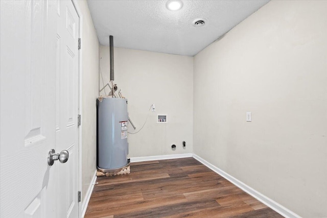 laundry area featuring dark wood-style floors, hookup for a washing machine, visible vents, electric water heater, and laundry area