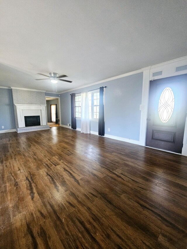 4596 Hickory Dr, Evans, GA 30809 - unfurnished living room featuring visible vents, a fireplace with raised hearth, ceiling fan, ornamental molding, and wood finished floors