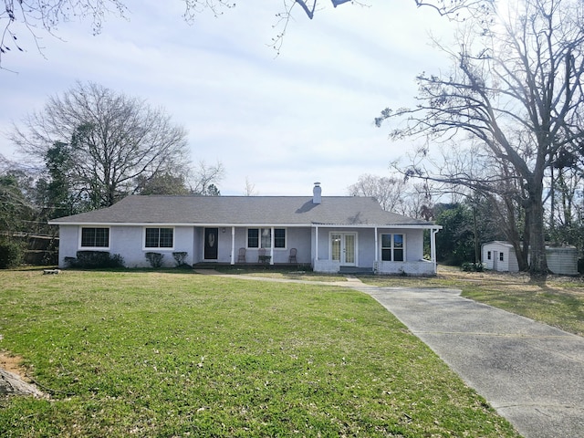 ranch-style house featuring a shed and a front lawn