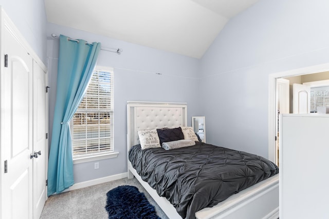 bedroom featuring lofted ceiling and light carpet