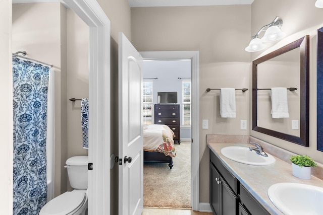 bathroom with walk in shower, vanity, and toilet