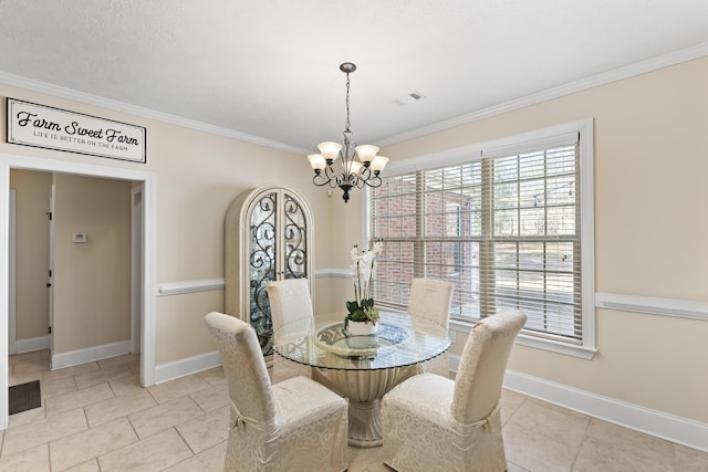 tiled dining area featuring an inviting chandelier and ornamental molding