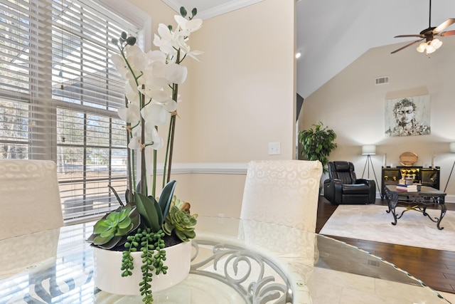 dining area with ceiling fan, ornamental molding, vaulted ceiling, and a wealth of natural light