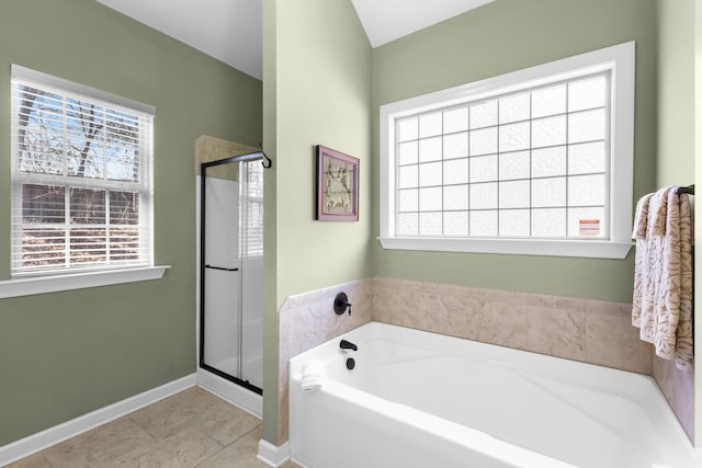 bathroom with independent shower and bath and tile patterned flooring