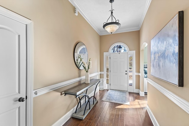 entrance foyer with ornamental molding and dark wood-type flooring