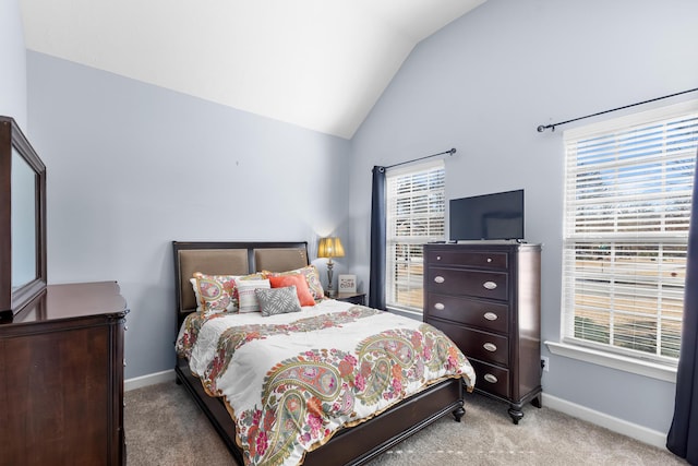 bedroom with vaulted ceiling and light colored carpet