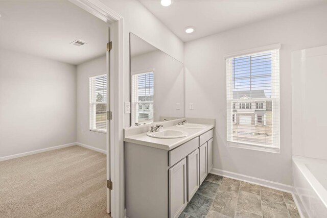 3447 Firestone Dr, Hephzibah, GA 30815 - full bath featuring visible vents, baseboards, a sink, and double vanity