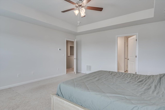 6093 Whitewater Dr, North Augusta, SC 29841 - bedroom with a tray ceiling, baseboards, light carpet, and a ceiling fan