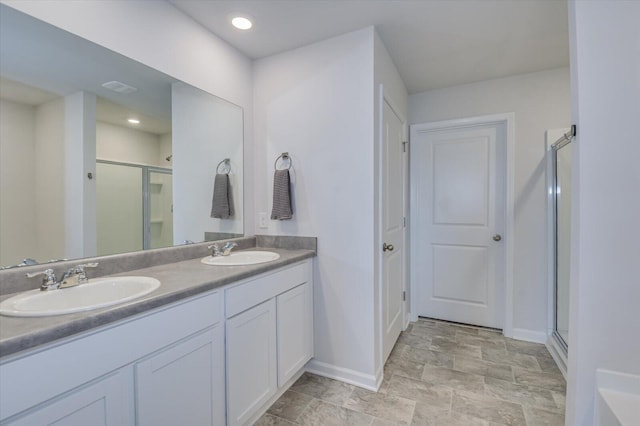 6093 Whitewater Dr, North Augusta, SC 29841 - bathroom with baseboards, a stall shower, double vanity, and stone finish flooring