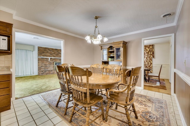 3009 Arcadia Ct, Augusta, GA 30906 - dining area with light tile patterned flooring, a chandelier, light carpet, and ornamental molding