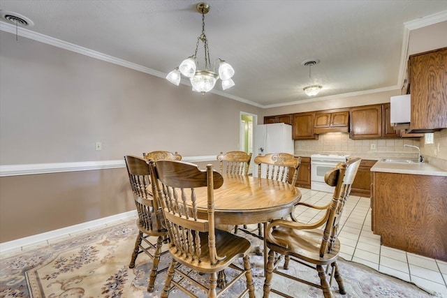 3009 Arcadia Ct, Augusta, GA 30906 - dining space with ornamental molding, light tile patterned floors, a chandelier, and baseboards
