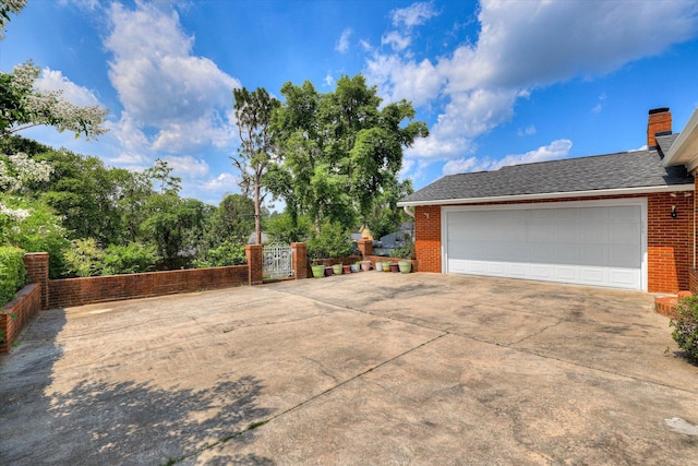 3009 Arcadia Ct, Augusta, GA 30906 - view of side of property with brick siding, a gate, a chimney, and a garage