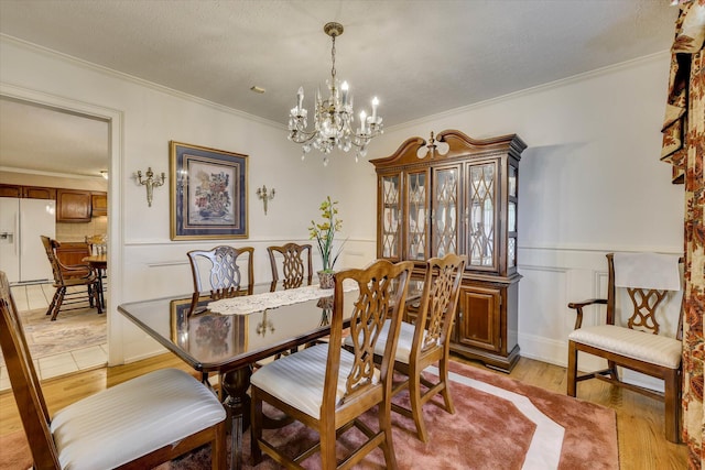 3009 Arcadia Ct, Augusta, GA 30906 - dining room featuring ornamental molding, a chandelier, light wood finished floors, and a wainscoted wall