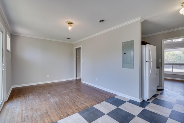 empty room with crown molding, electric panel, and baseboards