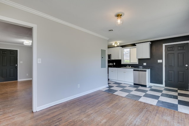 kitchen with ornamental molding, white cabinetry, baseboards, light floors, and dishwasher