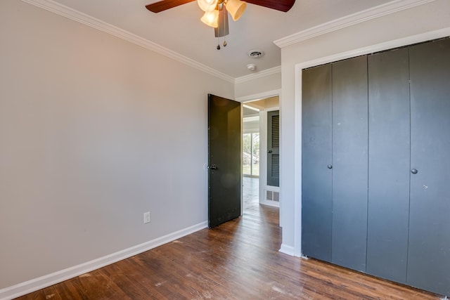 unfurnished bedroom featuring visible vents, baseboards, dark wood-style flooring, and ornamental molding