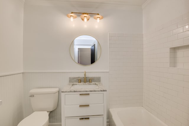 full bathroom featuring crown molding, washtub / shower combination, a wainscoted wall, toilet, and vanity