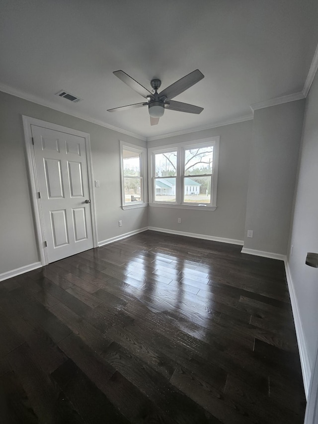 unfurnished bedroom with dark wood-type flooring, visible vents, and crown molding