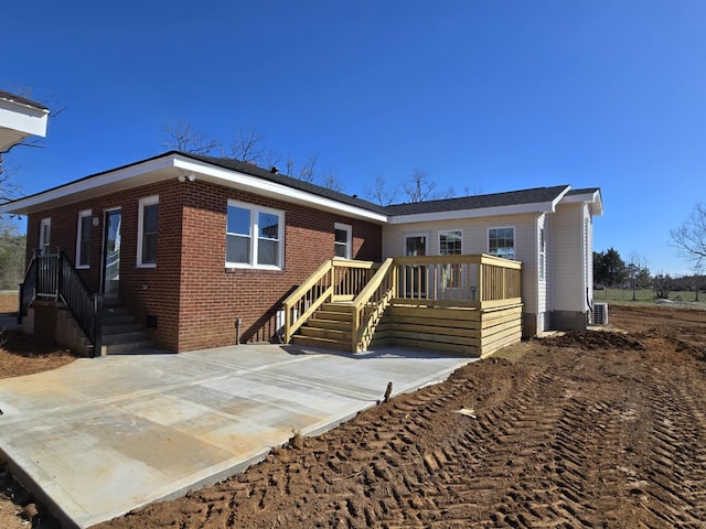 view of front facade featuring brick siding and a deck