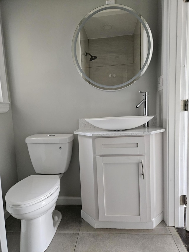 bathroom with vanity, tile patterned flooring, toilet, and baseboards