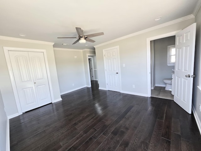 unfurnished bedroom with crown molding, a closet, baseboards, and dark wood-type flooring