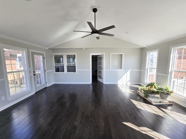 unfurnished living room featuring dark wood-style floors, ornamental molding, lofted ceiling, and baseboards