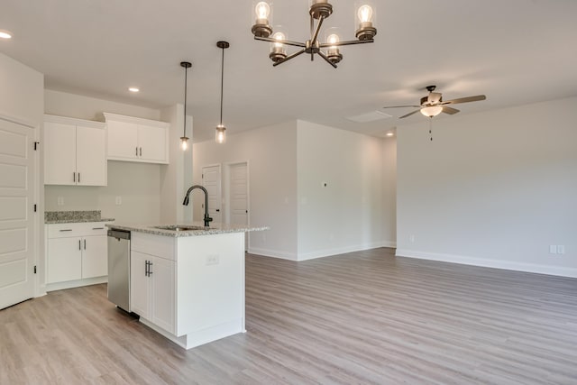 kitchen featuring a sink, light wood-style flooring, stainless steel dishwasher, and a kitchen island with sink