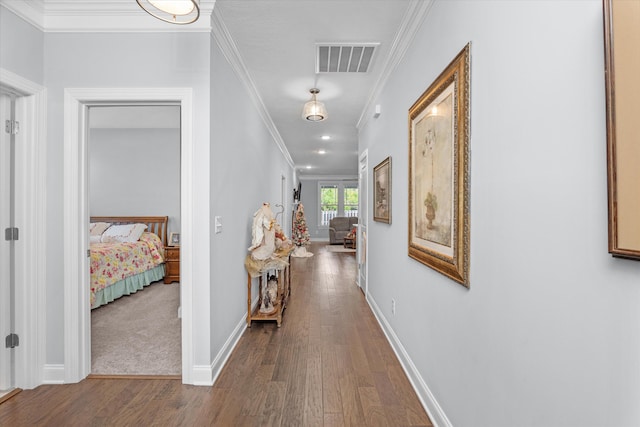 hall featuring hardwood / wood-style flooring and crown molding