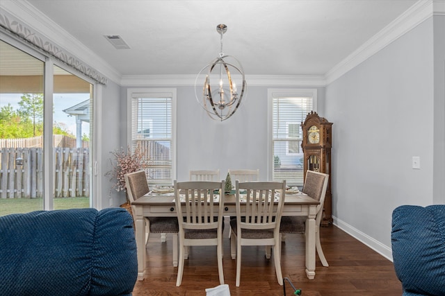 dining space with a healthy amount of sunlight, ornamental molding, dark wood-type flooring, and an inviting chandelier