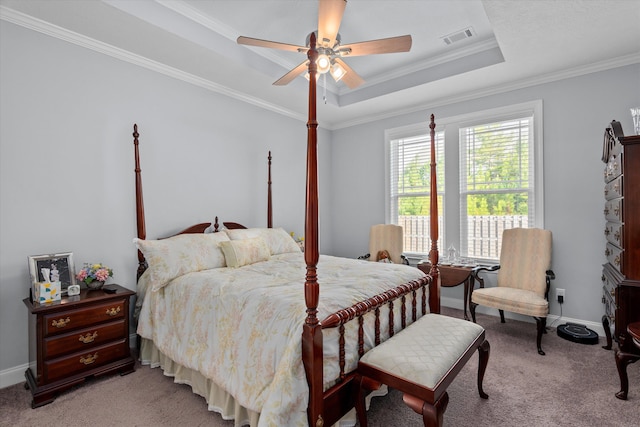 carpeted bedroom with a raised ceiling, ceiling fan, and ornamental molding