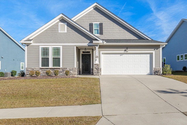 craftsman-style house featuring central air condition unit and a front yard