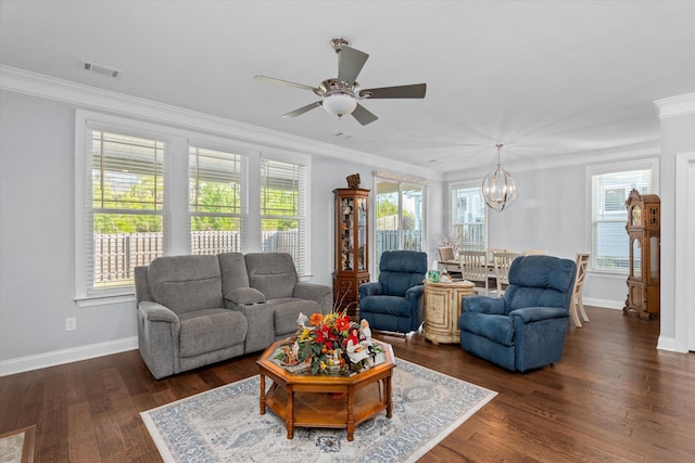 living room featuring ceiling fan with notable chandelier, dark hardwood / wood-style floors, and ornamental molding