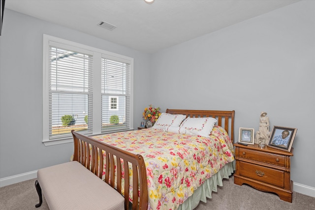 bedroom featuring light carpet