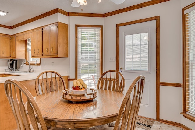dining room with light tile patterned floors, ornamental molding, and ceiling fan
