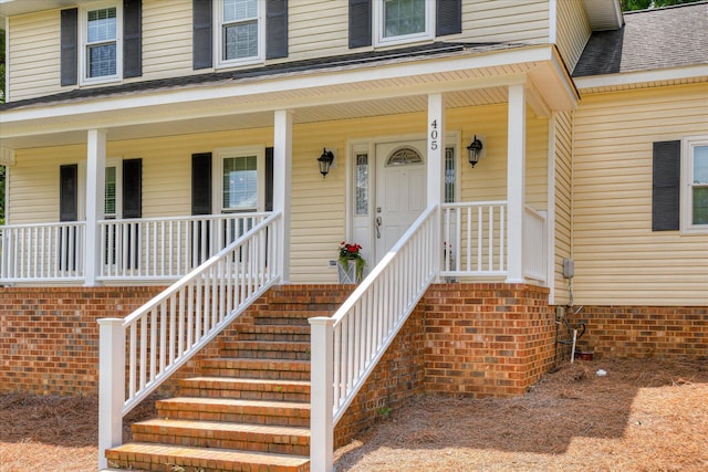 view of exterior entry featuring a porch