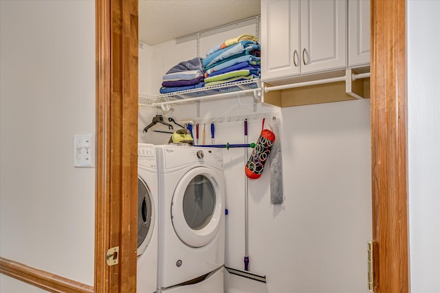 laundry area with cabinet space and washer and clothes dryer