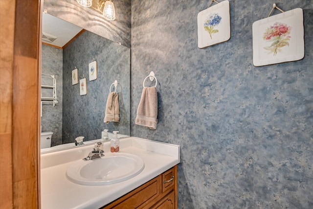 half bathroom with vanity and toilet