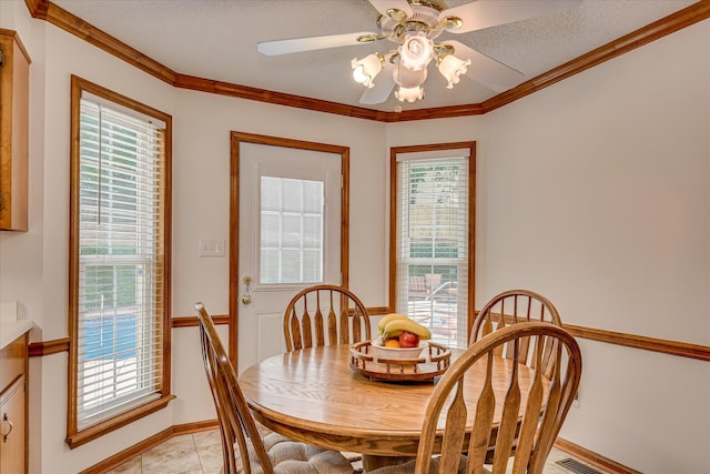 dining area featuring ornamental molding, baseboards, and ceiling fan