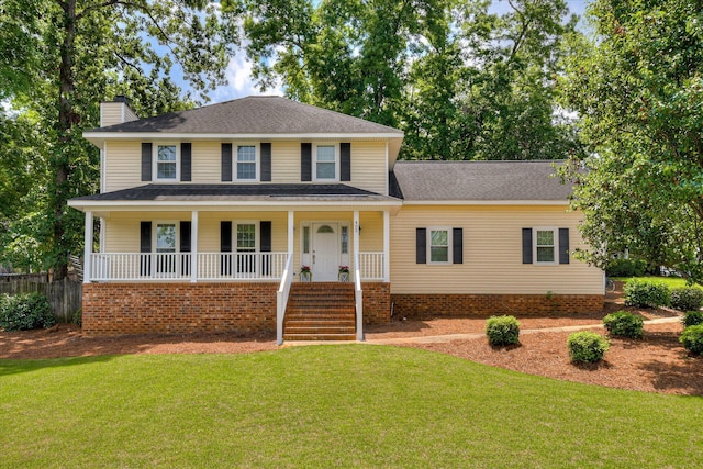view of front of property featuring a chimney, fence, a front lawn, a porch, and stairs