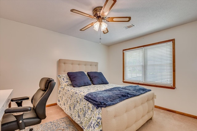bedroom featuring light carpet, baseboards, a ceiling fan, and visible vents
