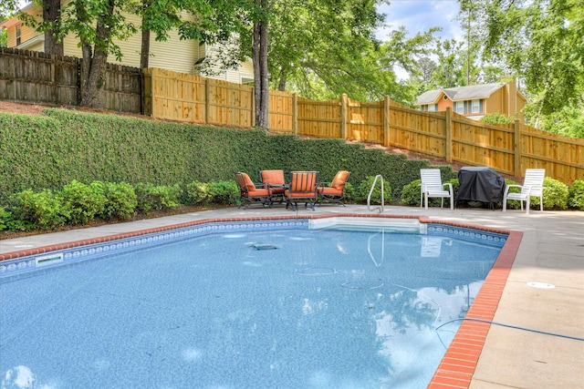 view of pool with a patio area, a fenced in pool, and a fenced backyard