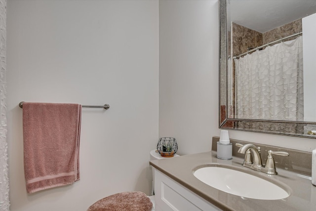 bathroom featuring vanity and curtained shower